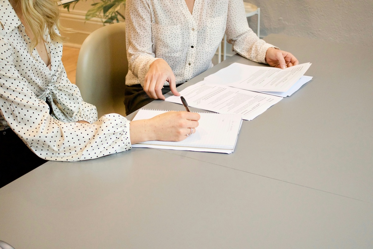 women-sign-documents Women sign documents